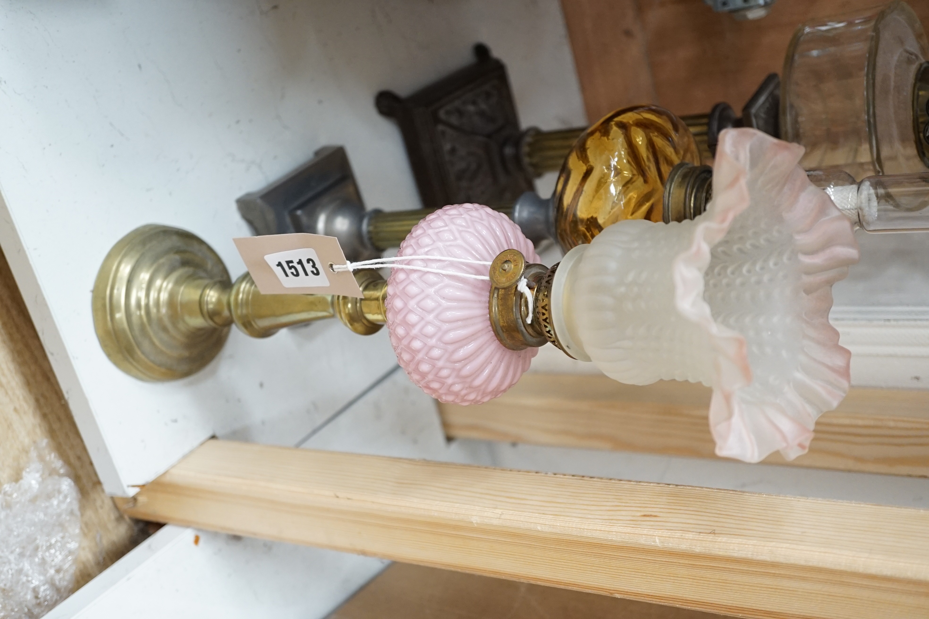 Three assorted glass and metal oil lamps, tallest 59cms excluding funnel